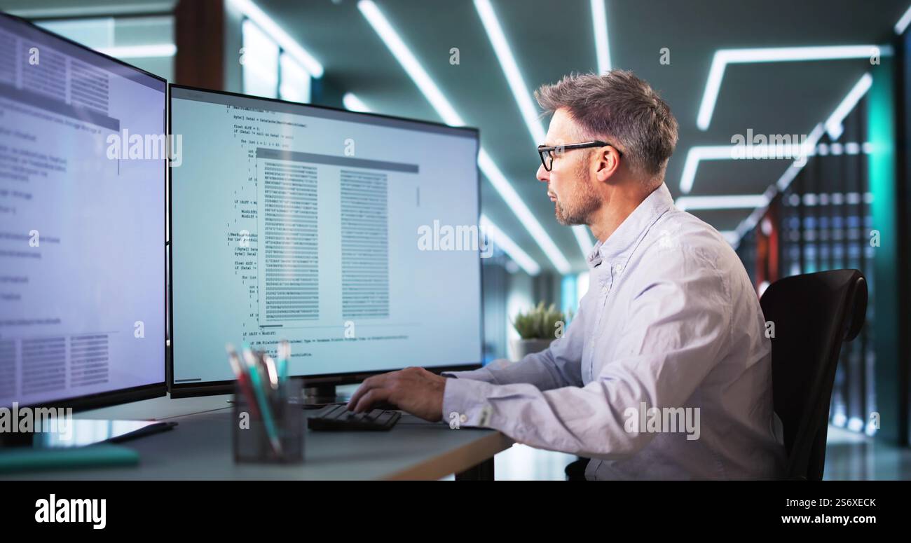 Software Programmer Or Coder Man Using Office Computer Stock Photo