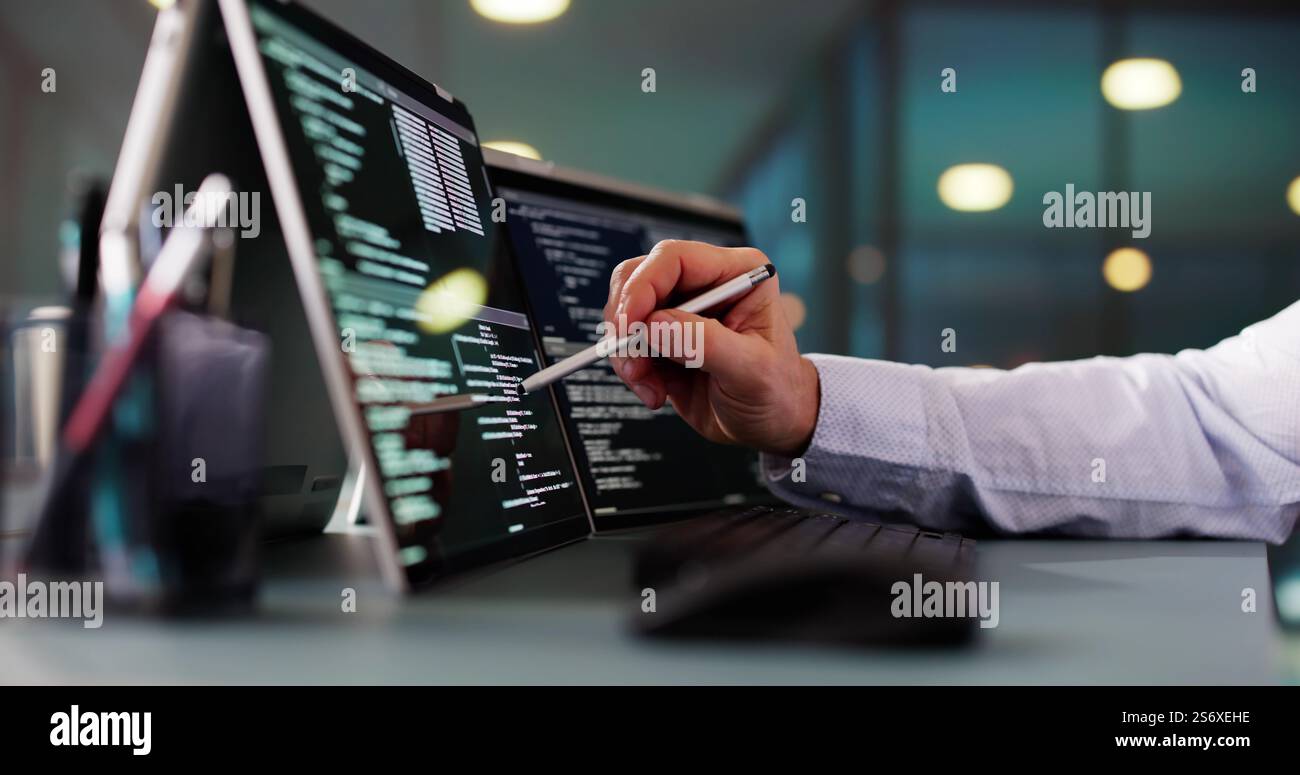 Programmer Or Coder At Office Desk Using Laptop Stock Photo