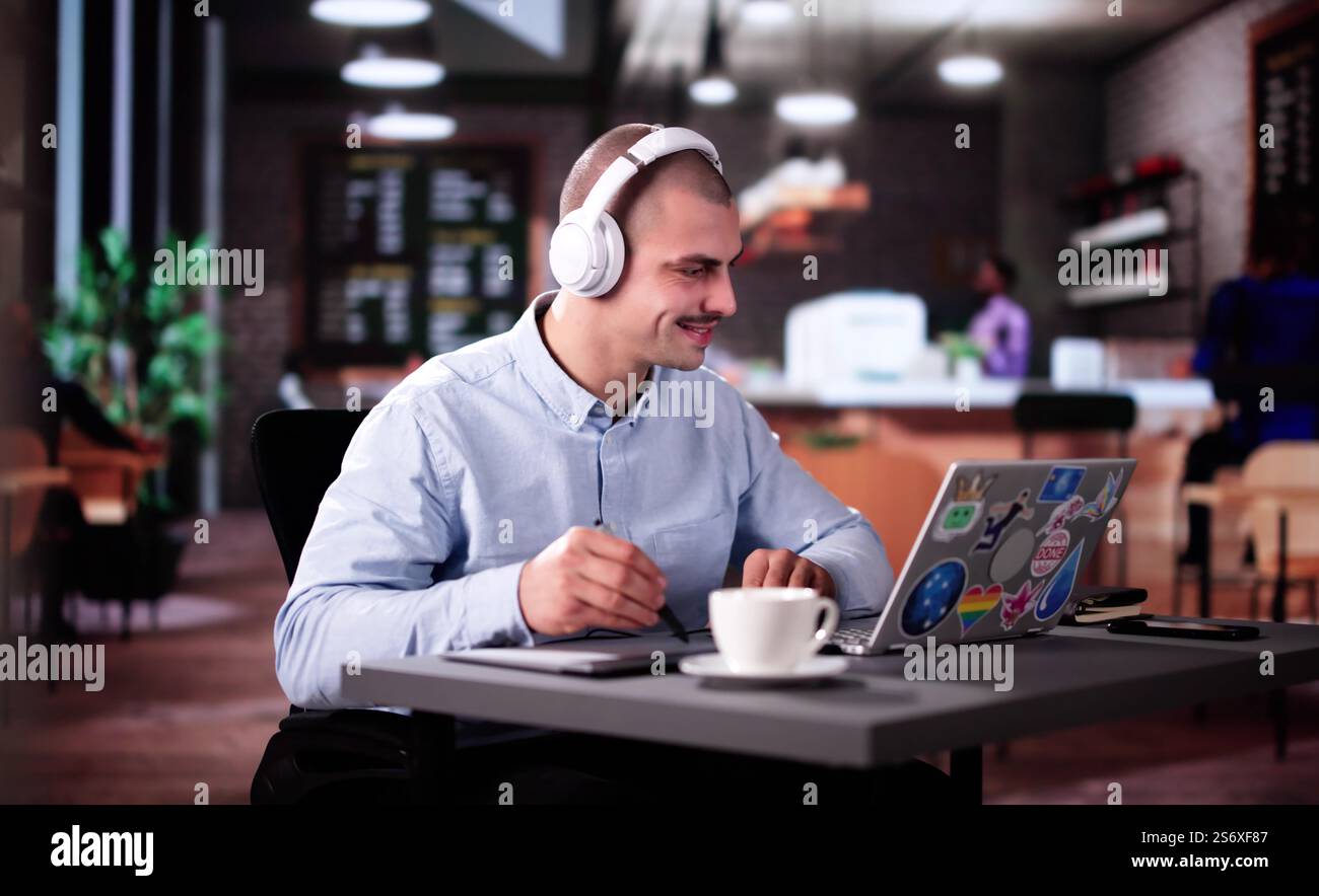 Graphic Photo Designer Using Computer Screen In Coffee shop Stock Photo