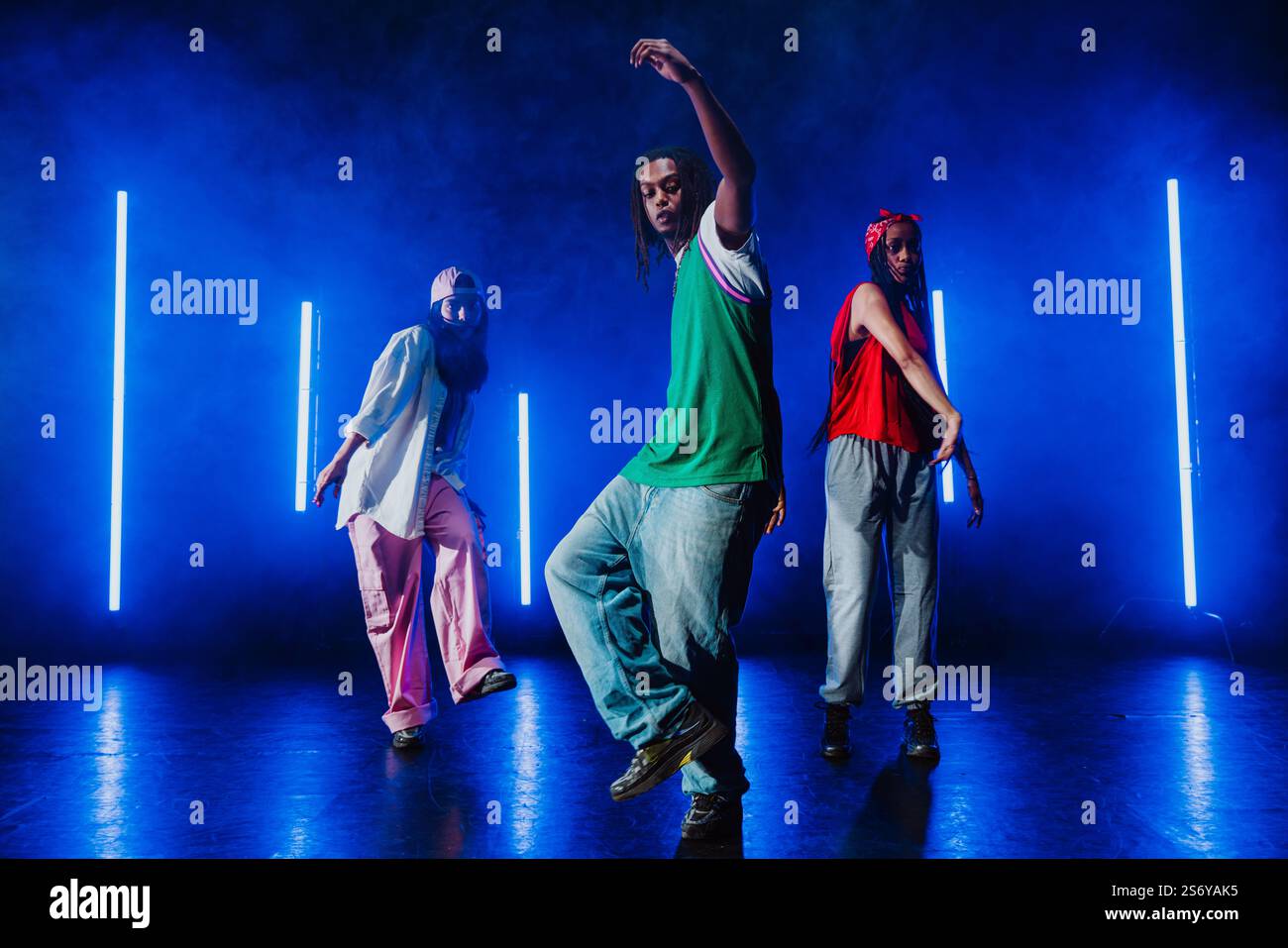 Group of hip hop dancer dancing together in a moody studio with tube ...