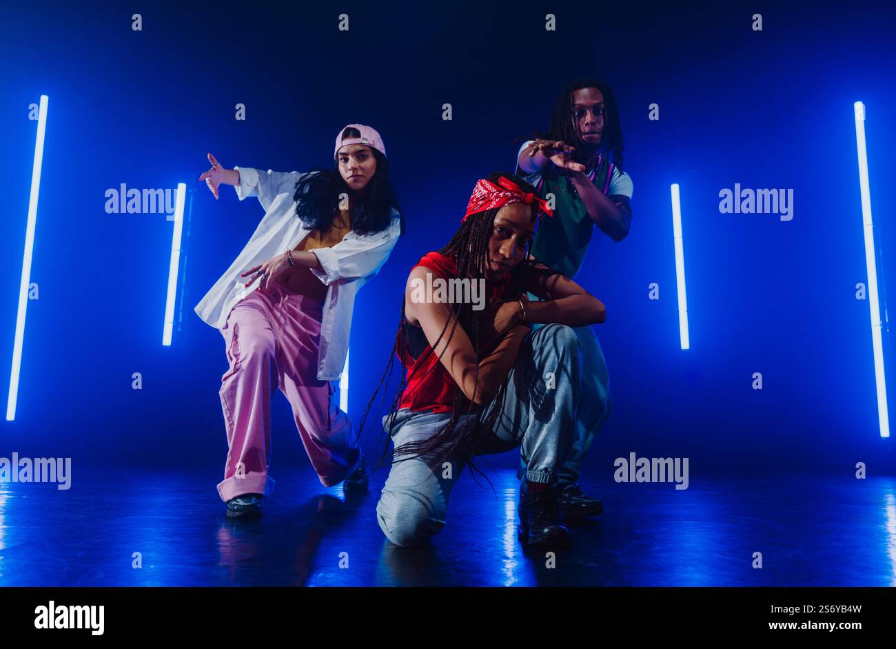 Group of hip hop dancer dancing together in a moody studio with tube ...
