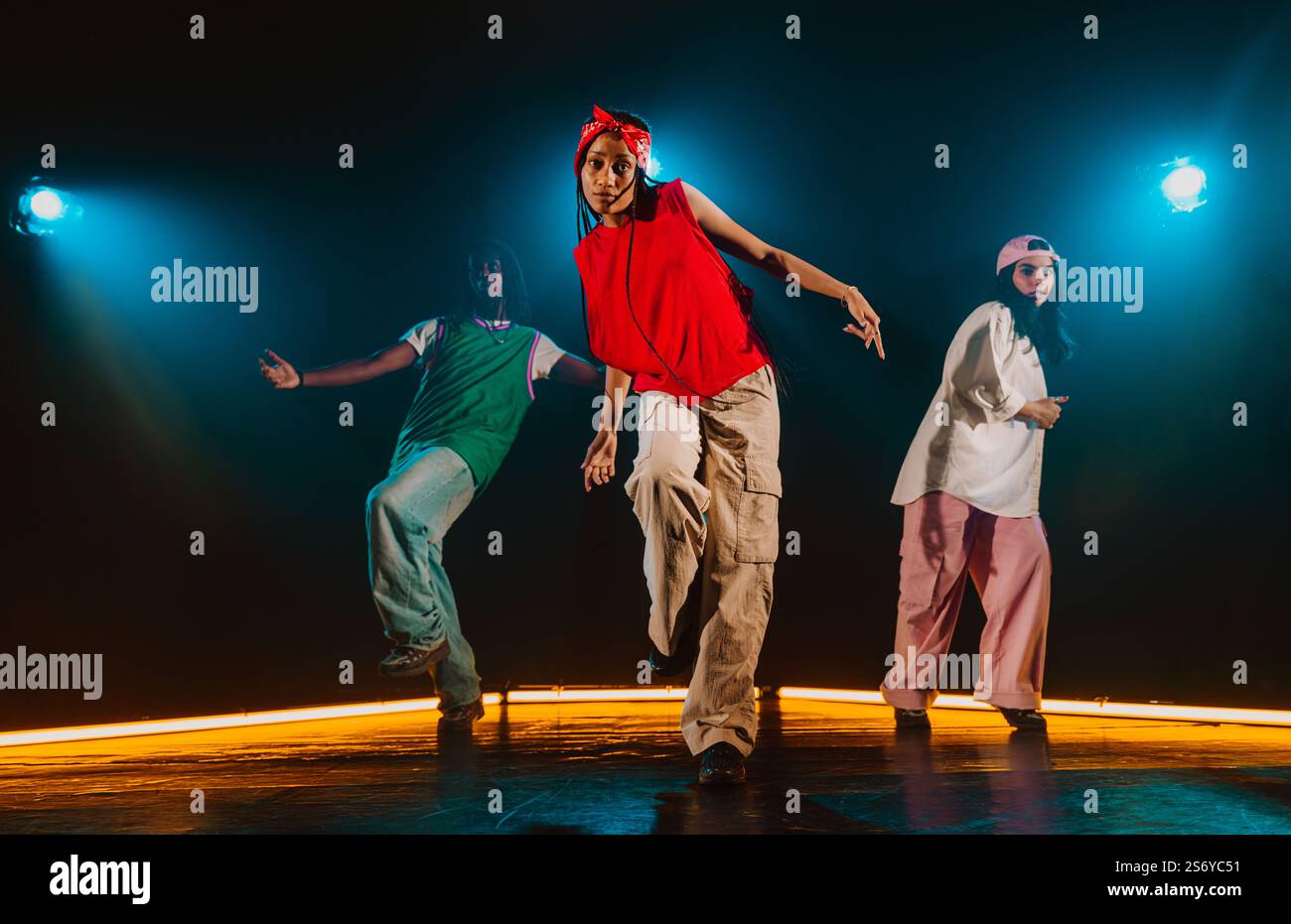 Group of hip hop dancer dancing together in a moody studio with tube ...