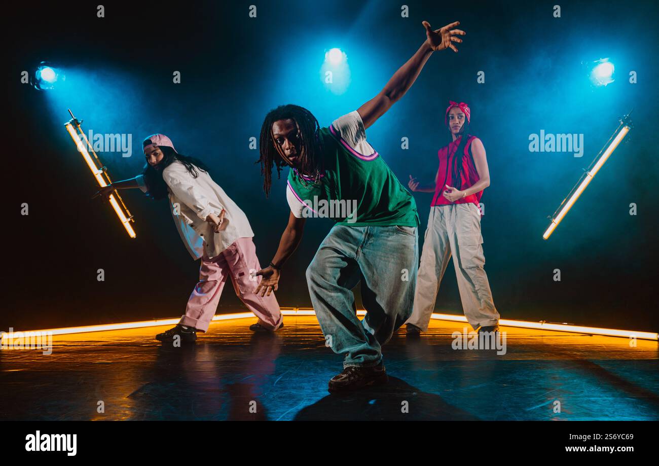 Group of hip hop dancer dancing together in a moody studio with tube ...