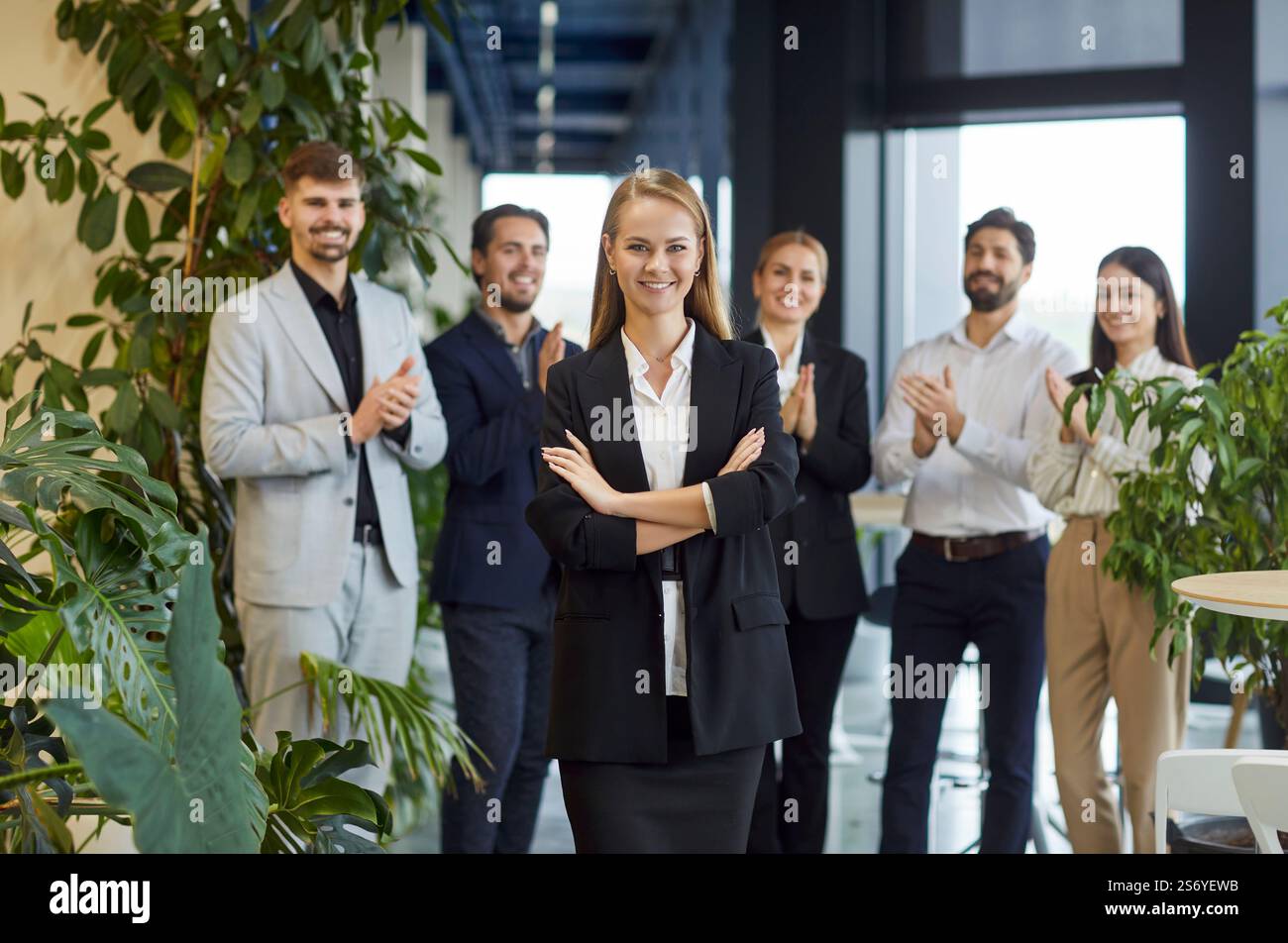Happy Businesswoman With Team In Office Stock Photo
