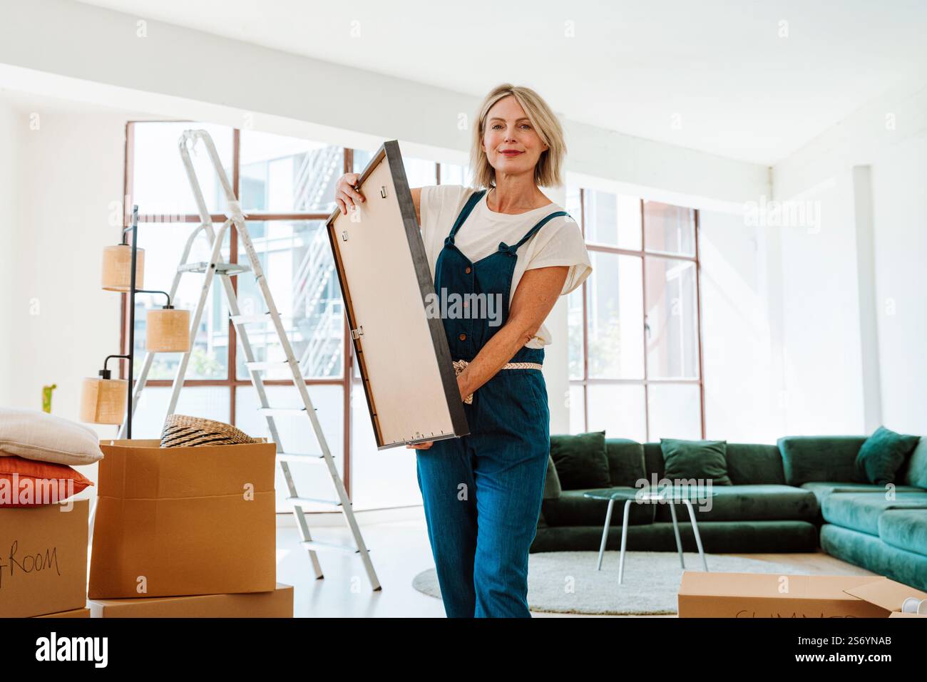 Single woman relocating in a new apartment. Middle aged senior ... - Relocating In Small Apartment