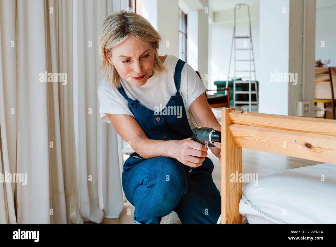 Single woman relocating in a new apartment. Middle aged senior ...