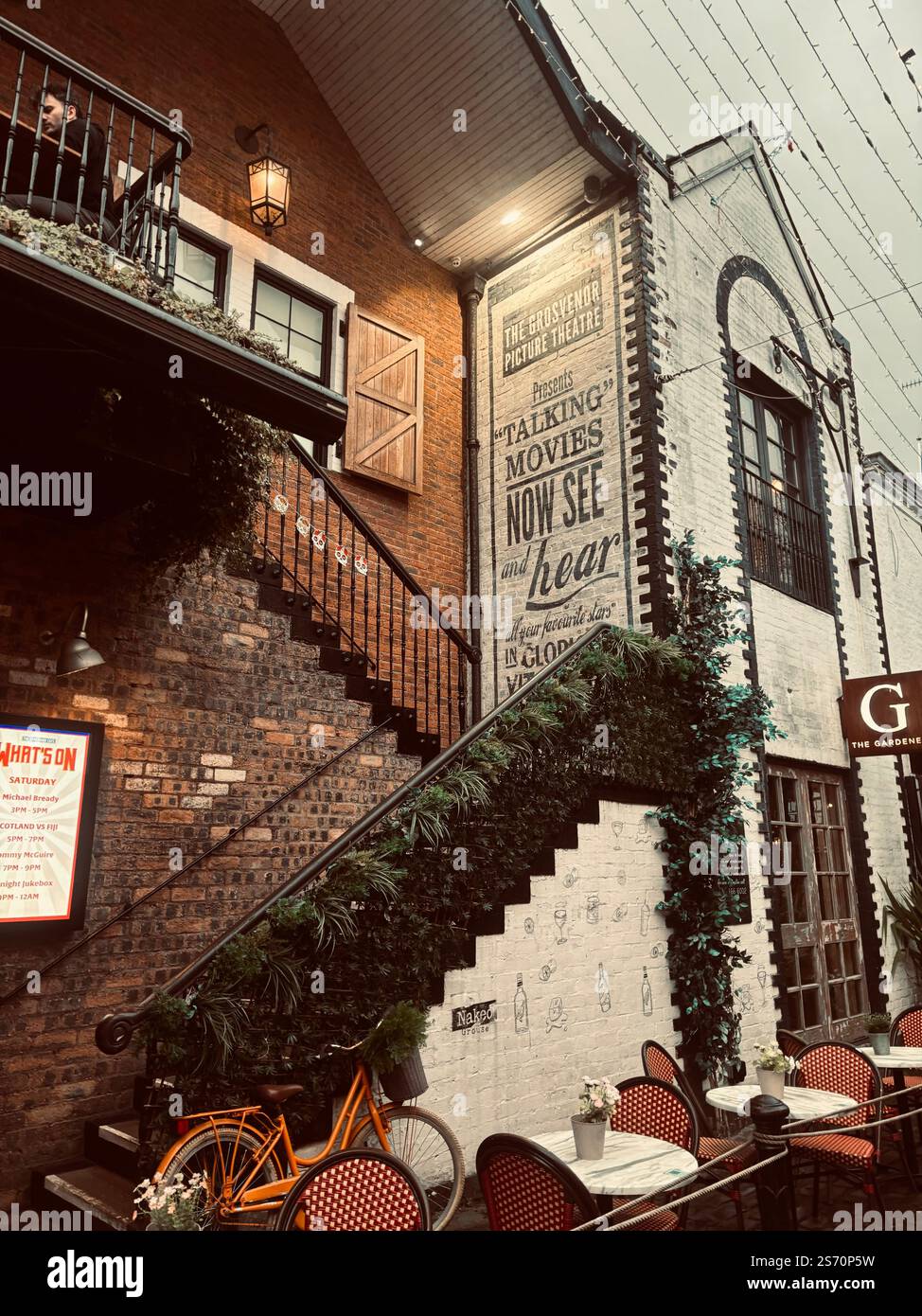 Urban alleyway in Glasgow with vintage signage and a warm glow. - Smartphone Captured Stock Image