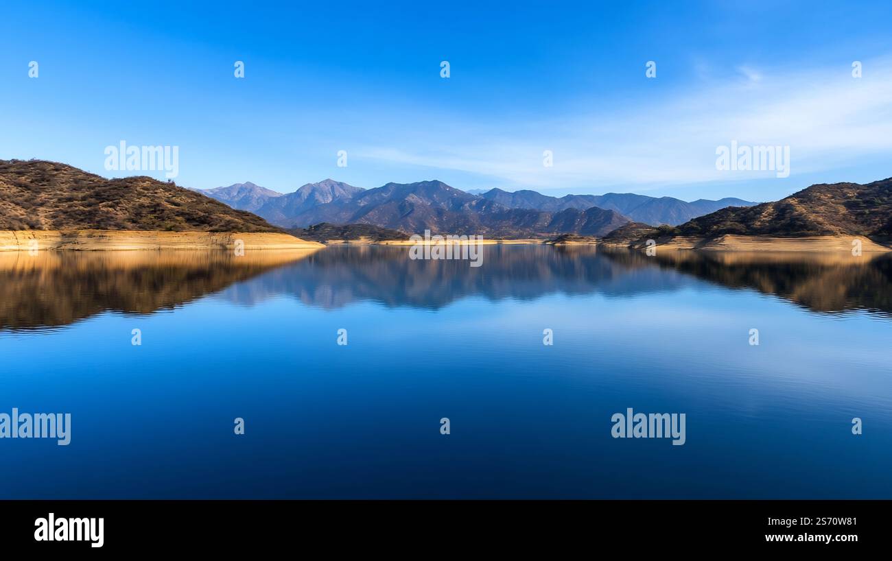 Serene mountain lake reflecting the surrounding alpine landscape in a ...