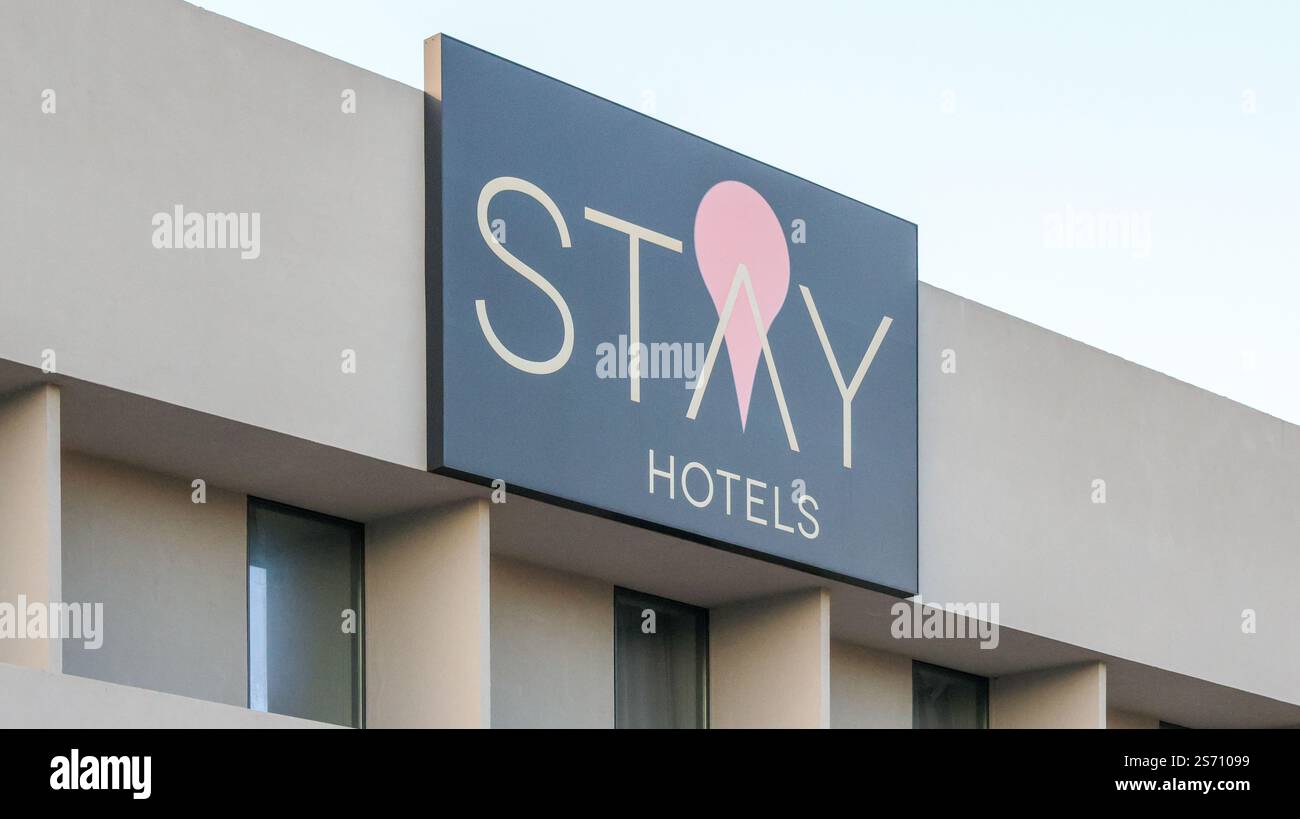 Modern hotel sign featuring a stylish logo and prominent placement on a ...