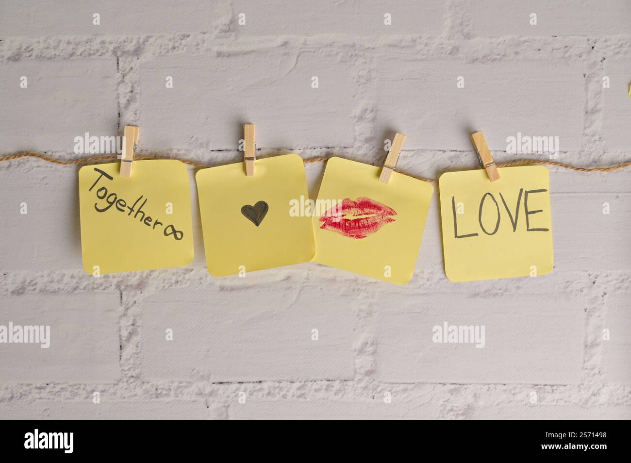 Four yellow sticker papers with lipstick kiss mark, inscription