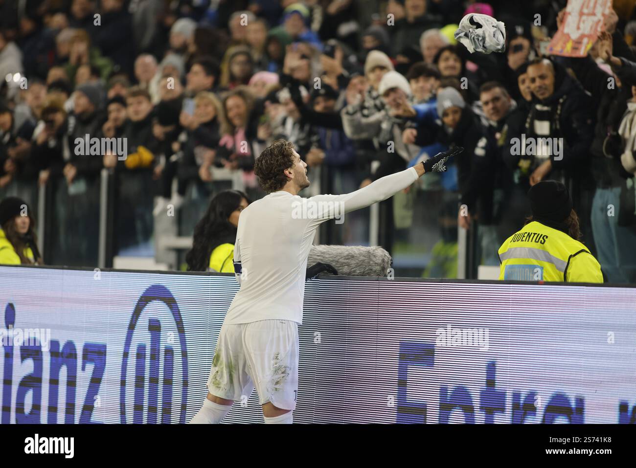 Manuel Locatelli of Juventus FC throwing his jersey to a fan during the