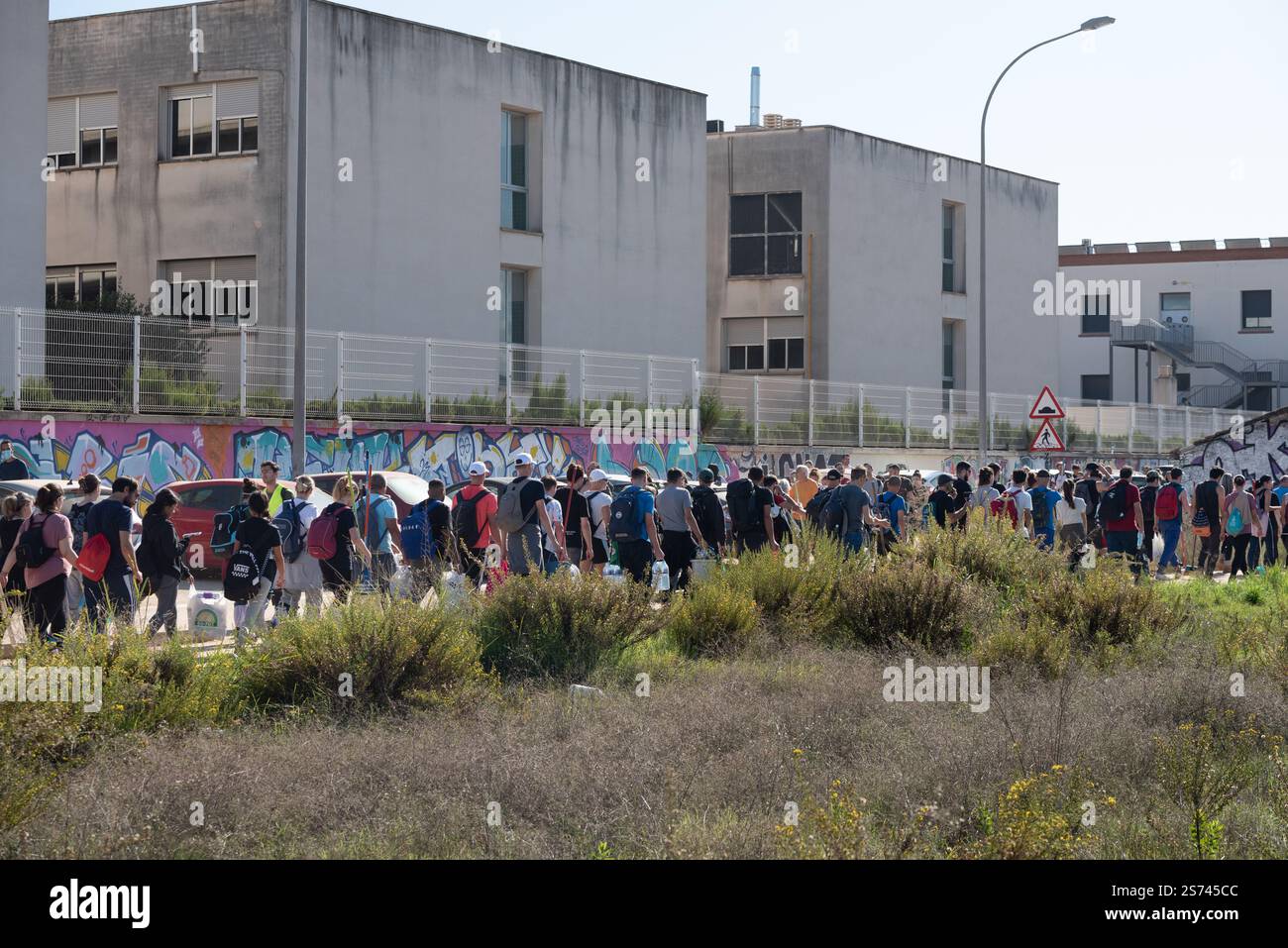 Long line of people volunteers walking toward affected zones by DANA flooding to provide help. Valencia, Spain Stock Photo