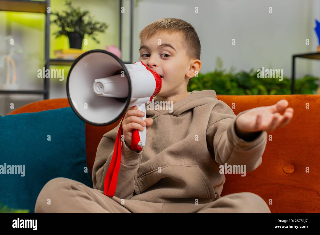 Preteen child boy talking with megaphone, proclaiming news, loudly ...