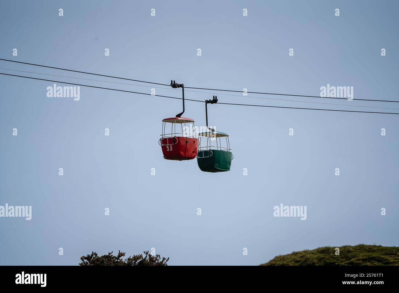 a passenger cable car gondola cabin travelling between pylons, opened ...