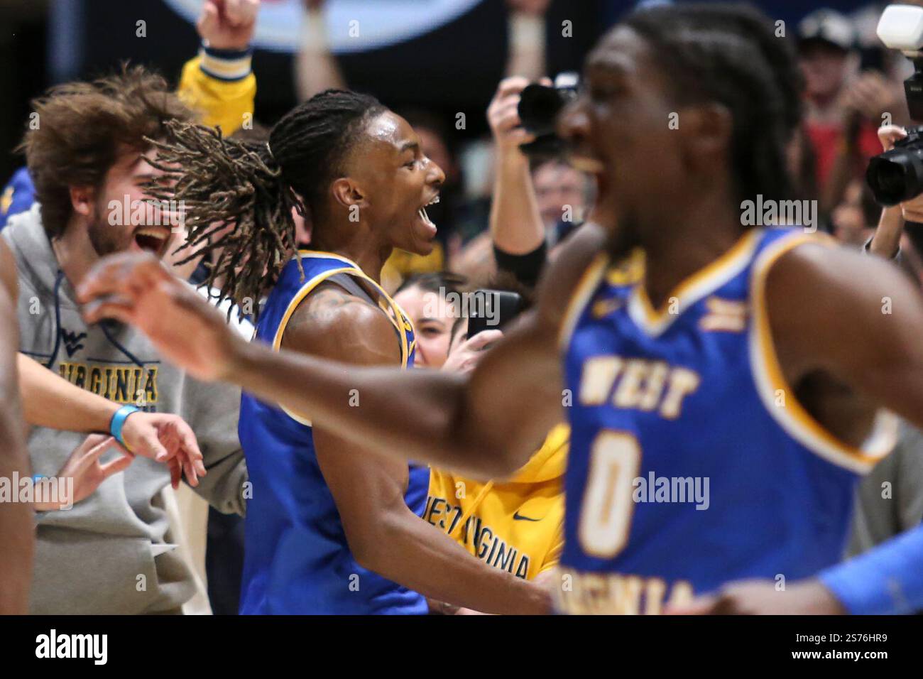 West Virginia guard Javon Small (7) celebrates with the students after