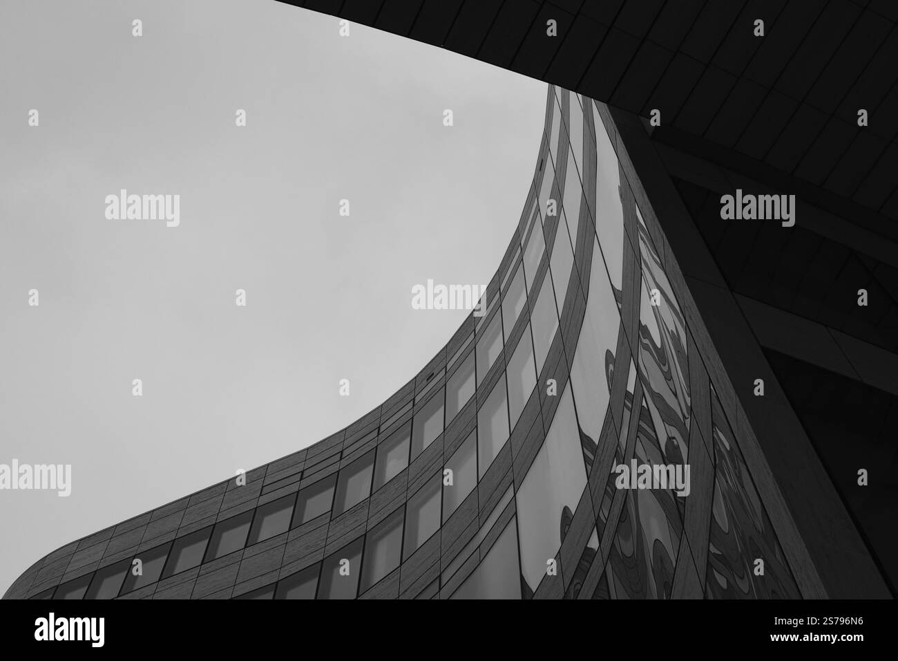 Wave-shaped building in the historic city centre, black and white ...