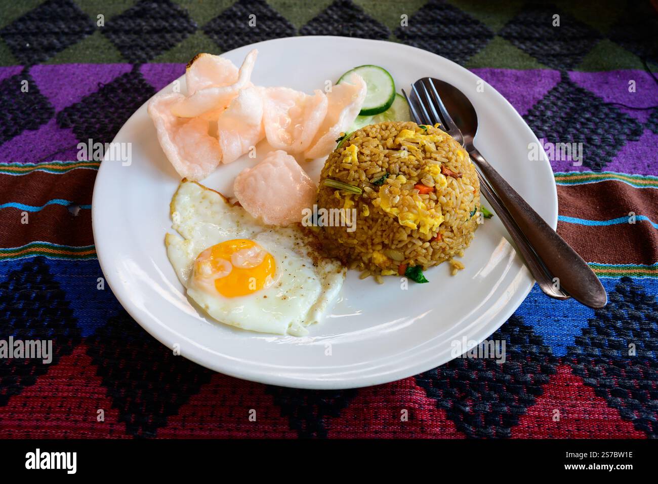 Nasi Goreng Authentic Indonesian Fried Rice with an Egg and Krupuk Crackers Stock Photo