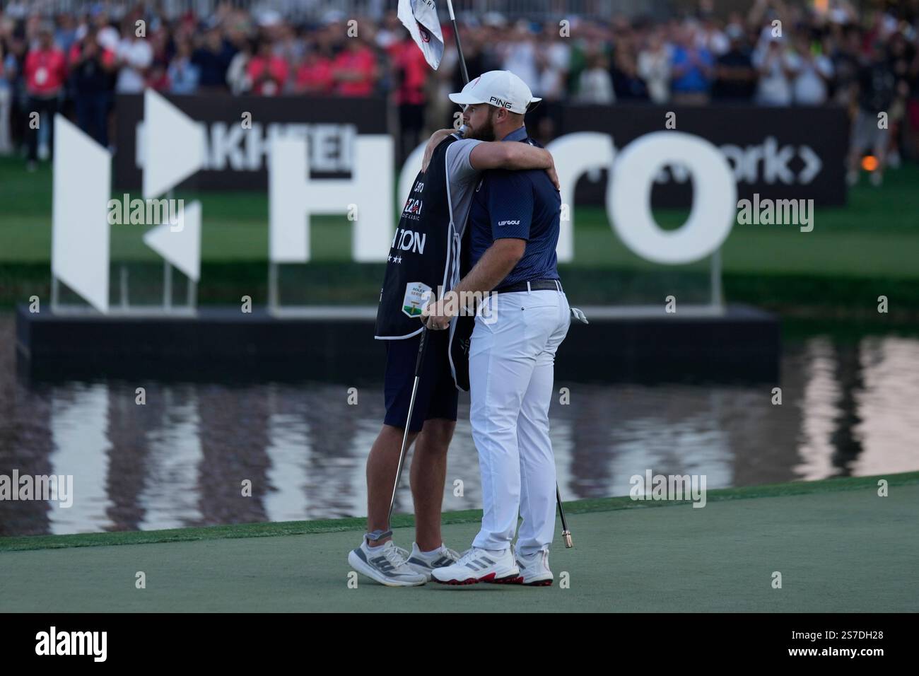 Tyrell Hatton of England and his caddie celebrate after winning the