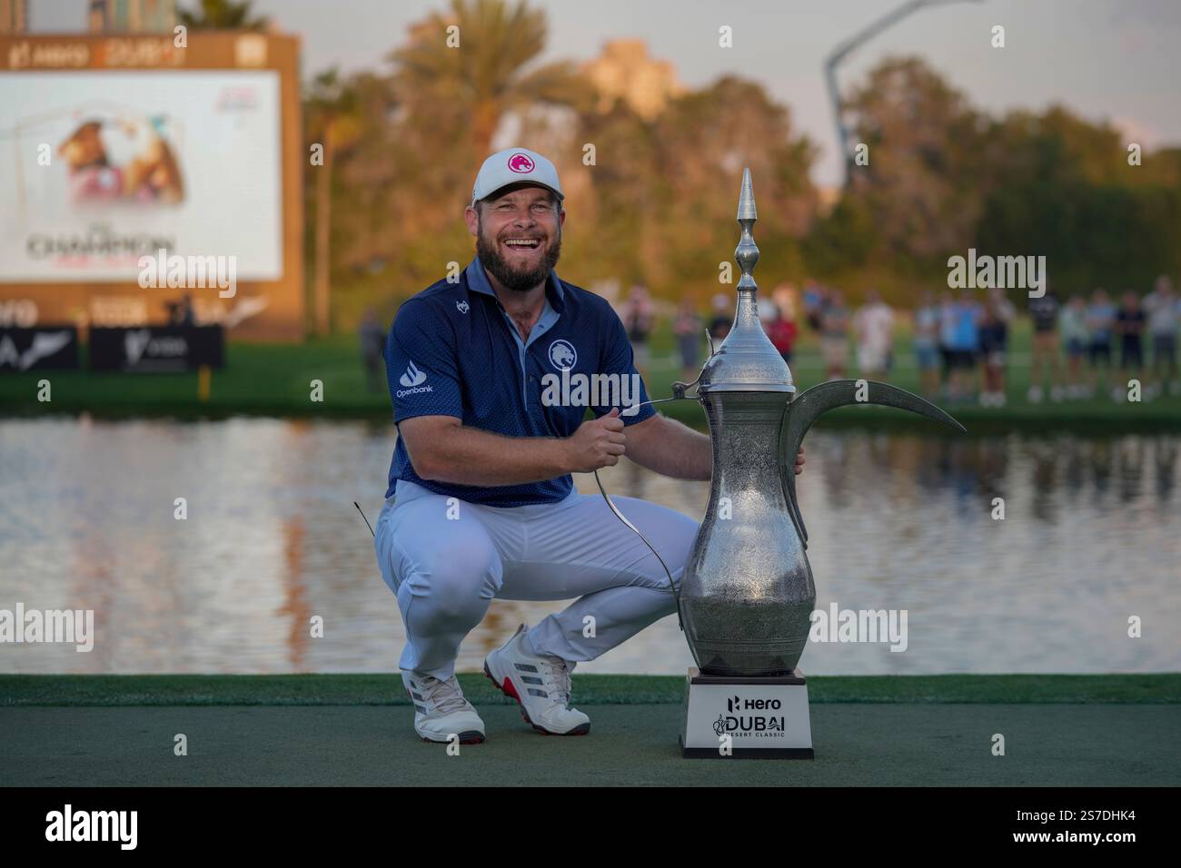 Tyrell Hatton of England poses with the trophy after winning the Dubai