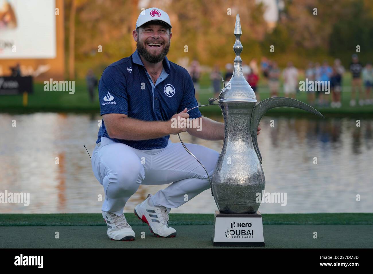 Tyrell Hatton of England poses with the trophy after winning the Dubai