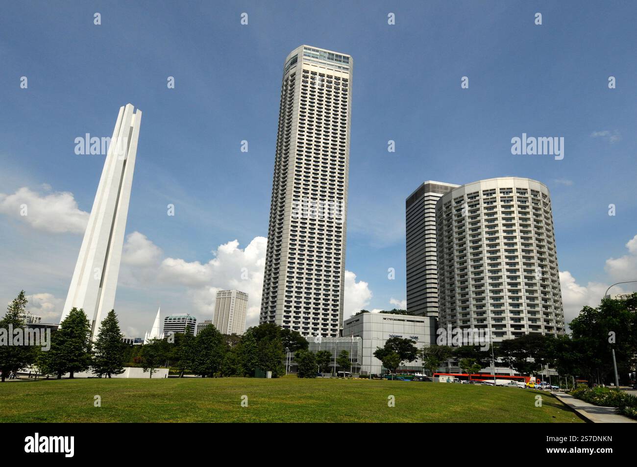 The Singapore white World War 11 Memorial, Swissotel The Stamford Singpore (middle) and the Fairmont Singapore hotel in Singapore. Stock Photo