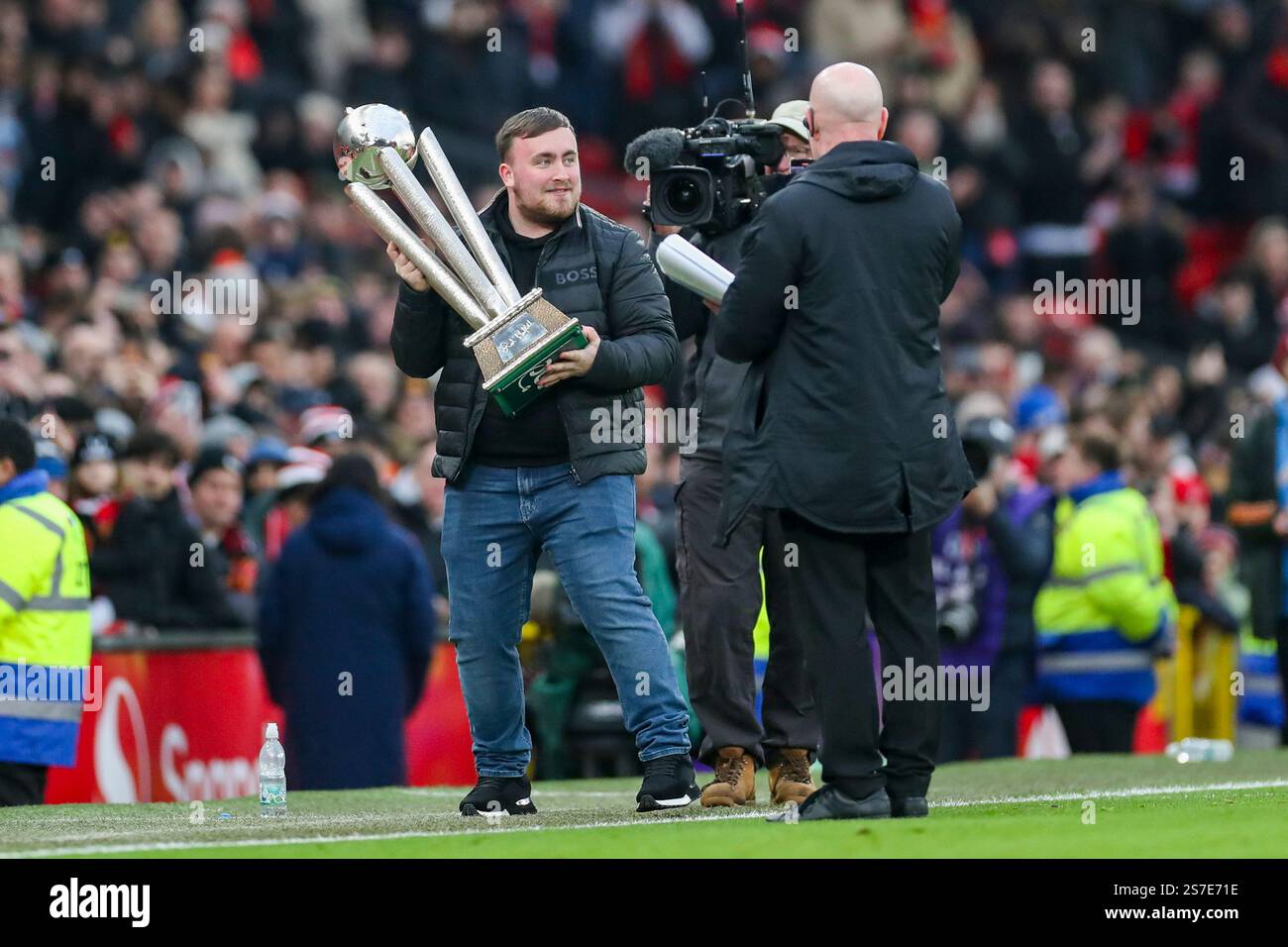 Luke Littler with the PDC trophy during the Manchester United FC v Brighton and Hove Albion FC