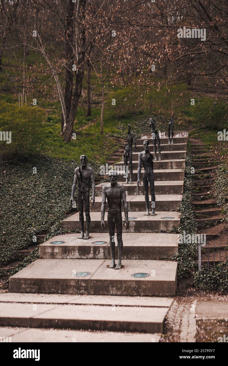 Prague, Czech republic - March 27, 2023: Bronze statues ascending concrete stairs in petrin hill park, Memorial to the victims of communism Stock Photo