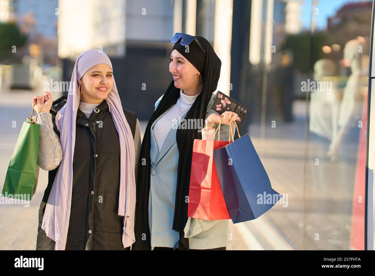Two muslim women holding shopping bags and enjoying a day out Stock ...