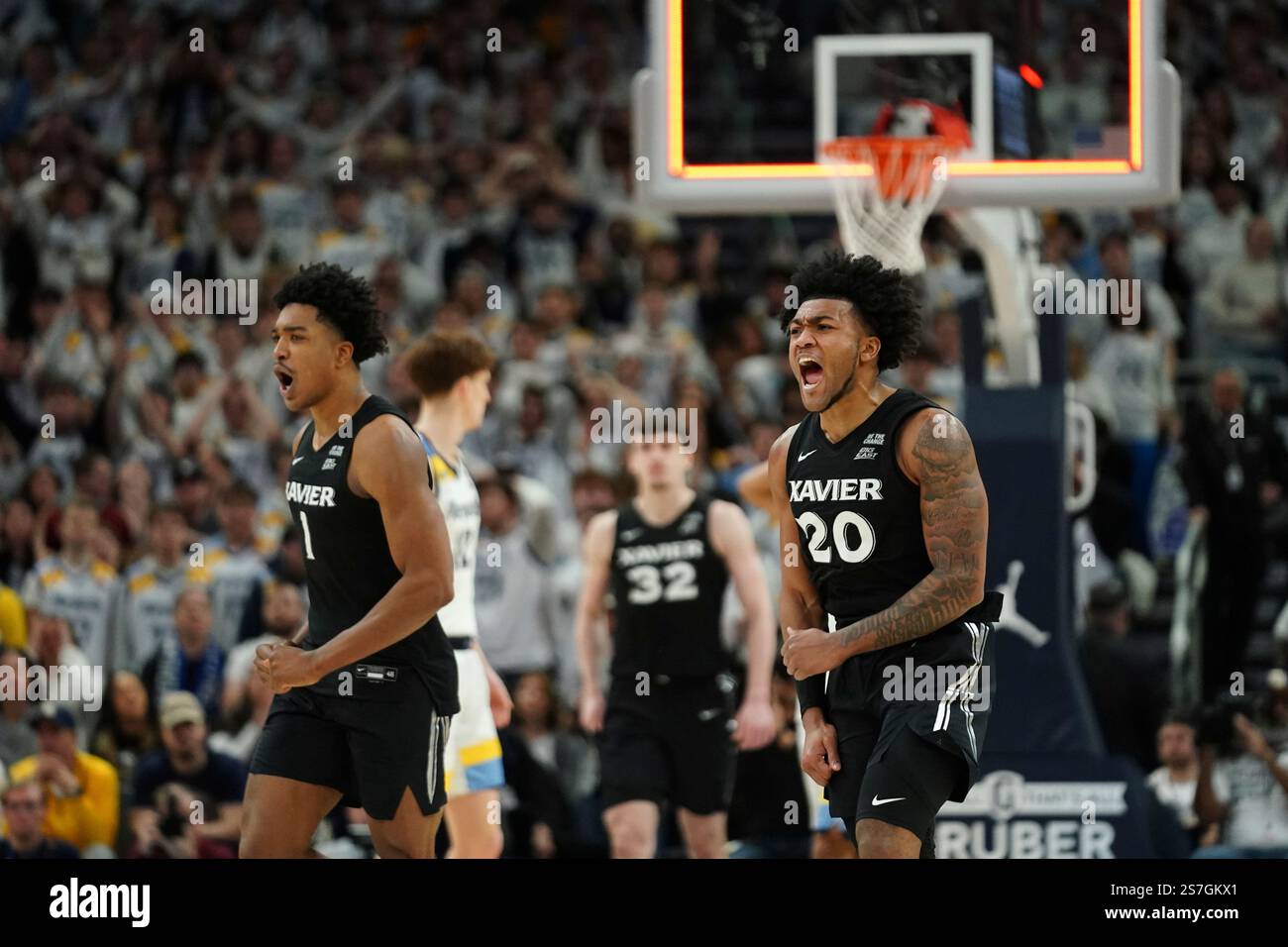 Xavier's Dayvion McKnight (20) and Marcus Foster (1) react after an ...