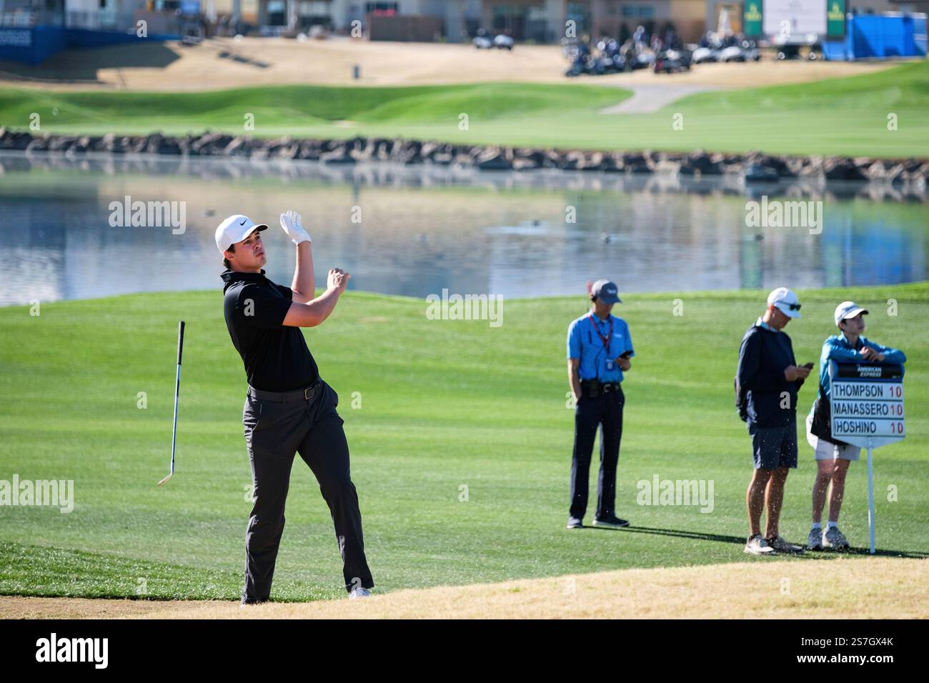 Davis Thompson drops his club after hitting from the 10th fairway at