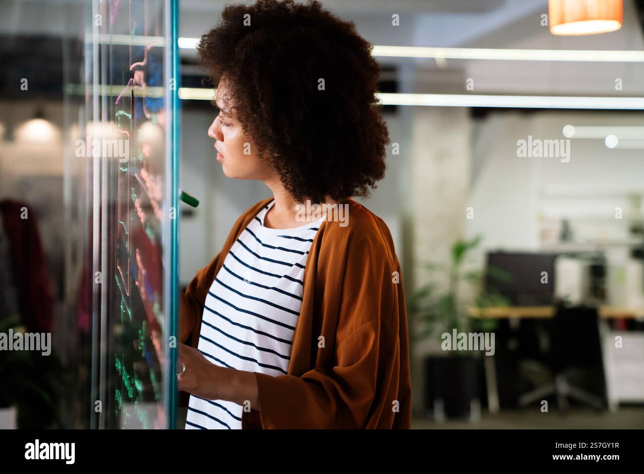 Portrait of african american female IT developer, programmer, designer working with programming code Stock Photo
