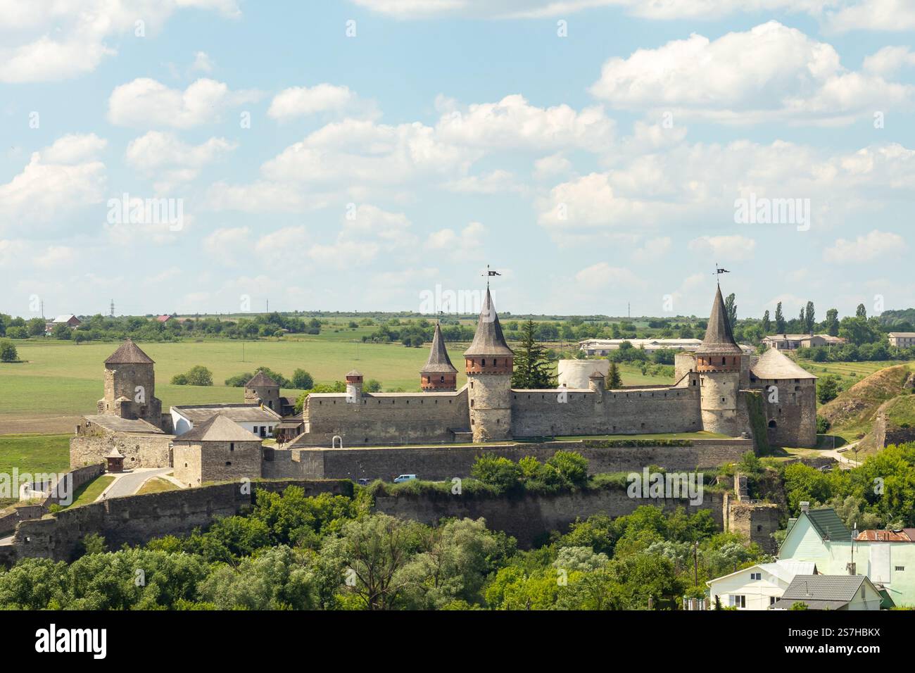 Historic medieval castle with towers under a blue sky and green ...