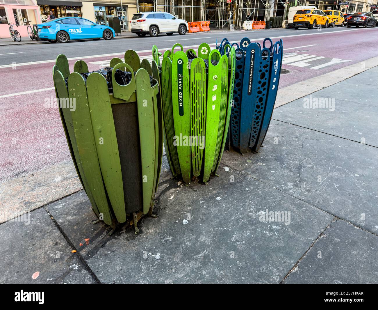 Three colorful trash cans on sidewalk for recycling with mixed paper, and metal and plastic, and the rest in the third, New York City, NY, USA - Smartphone Captured Stock Image