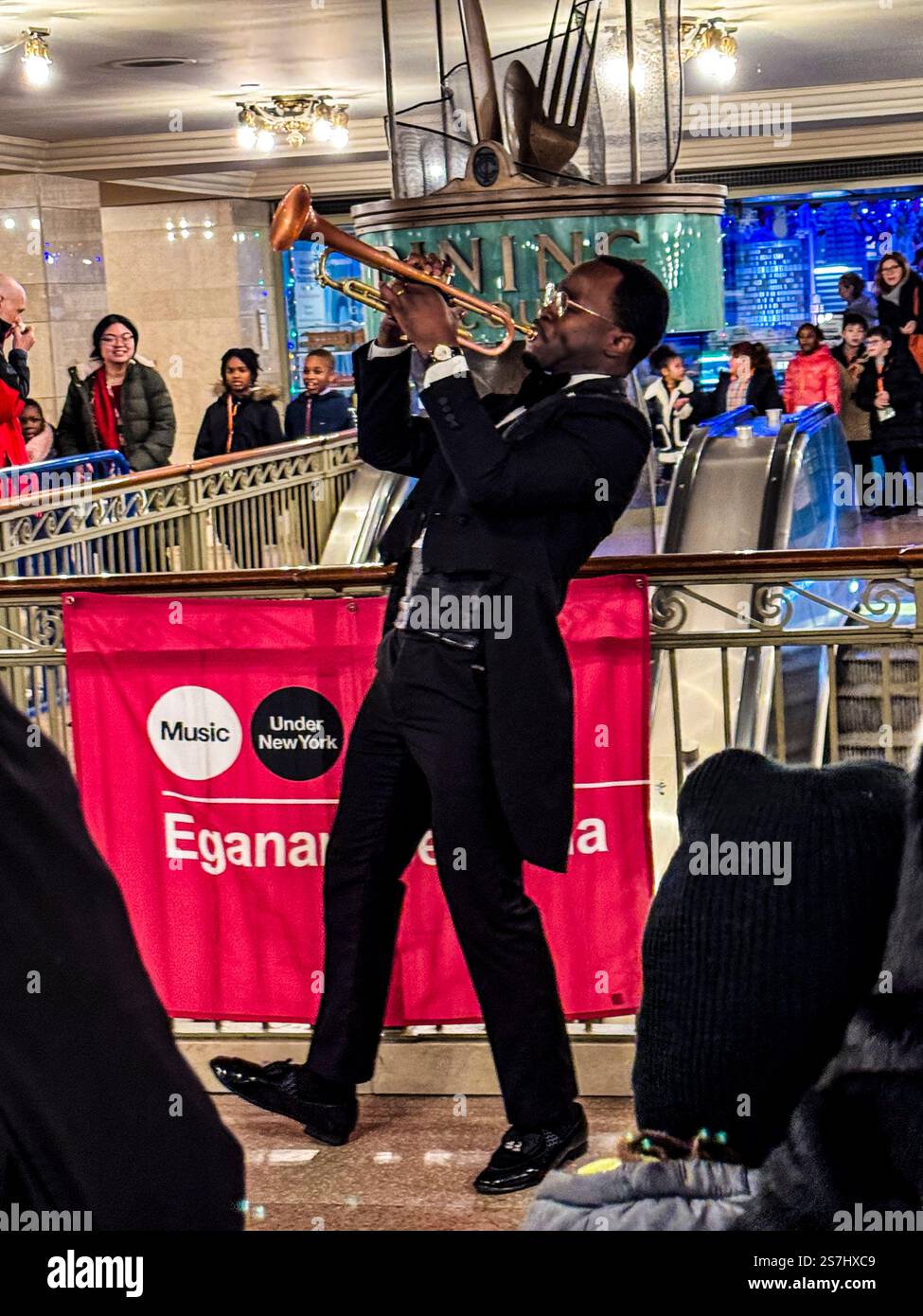 Trumpeter Eganam “ÉGO” Segbefia busking at Grand Central Station as part of the MTA's Music Under New York, New York City, NY, USA - Smartphone Captured Stock Image