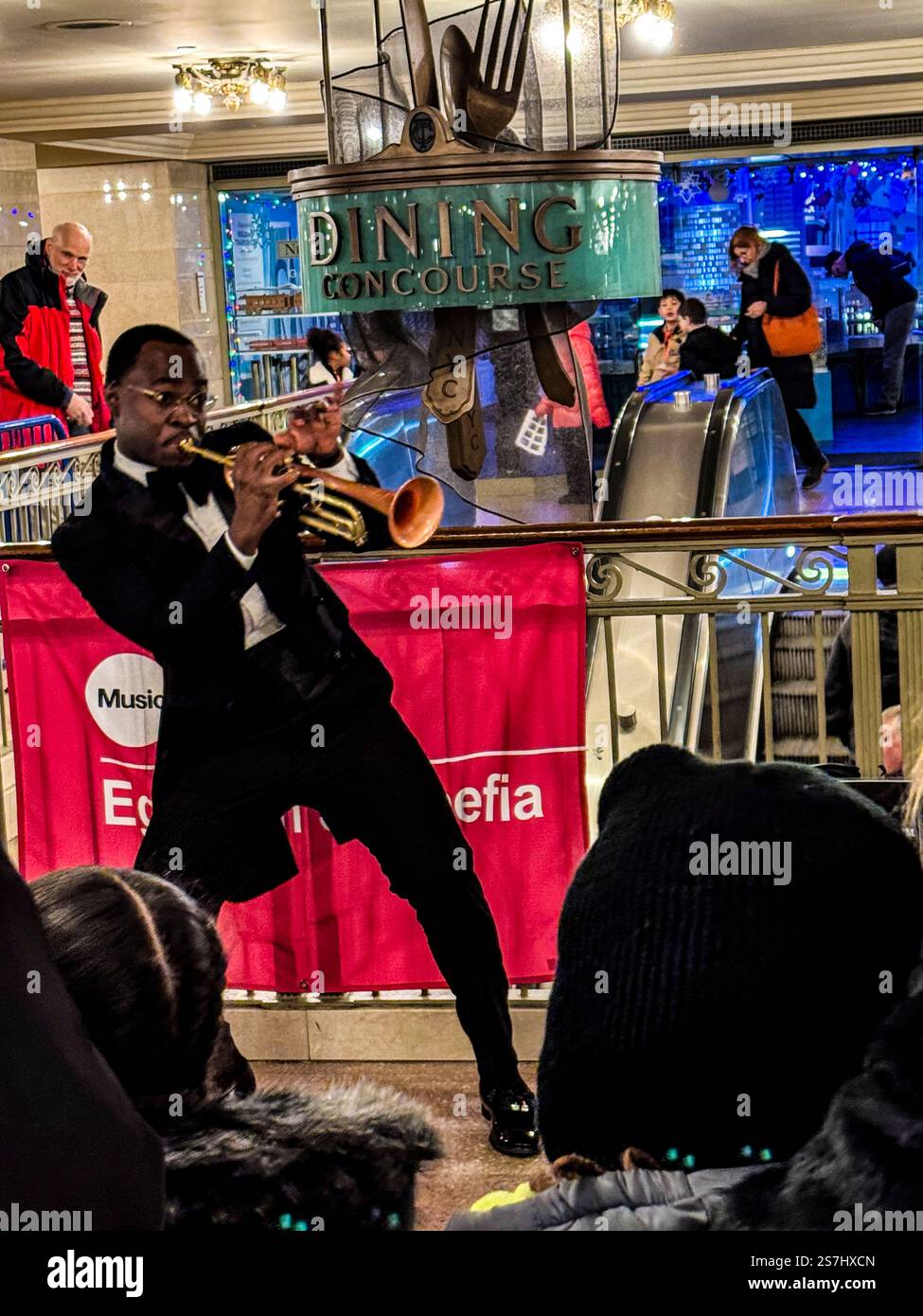 Trumpeter Eganam “ÉGO” Segbefia busking at Grand Central Station as part of the MTA's Music Under New York, New York City, NY, USA - Smartphone Captured Stock Image