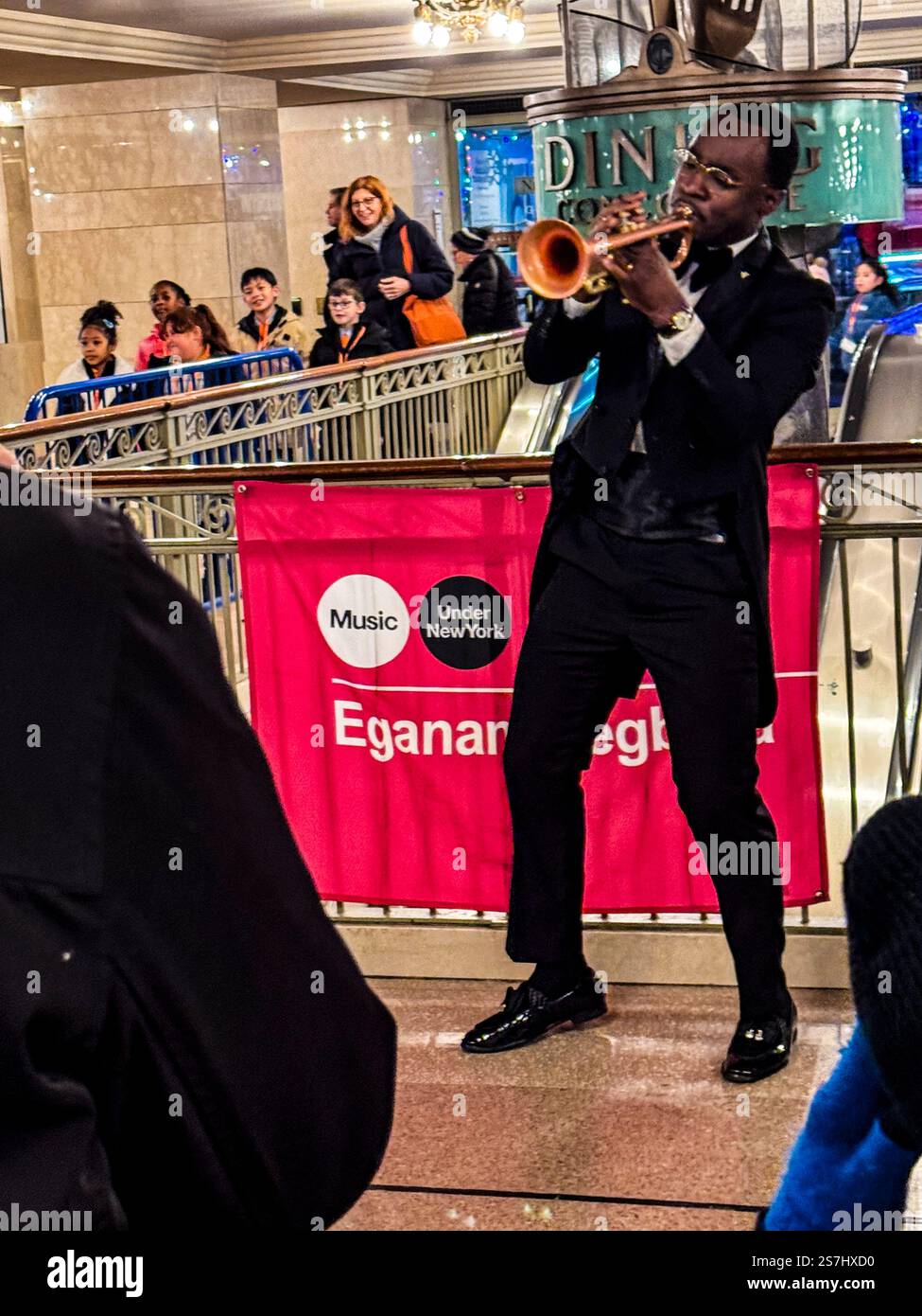 Trumpeter Eganam “ÉGO” Segbefia busking at Grand Central Station as part of the MTA's Music Under New York, New York City, NY, USA - Smartphone Captured Stock Image