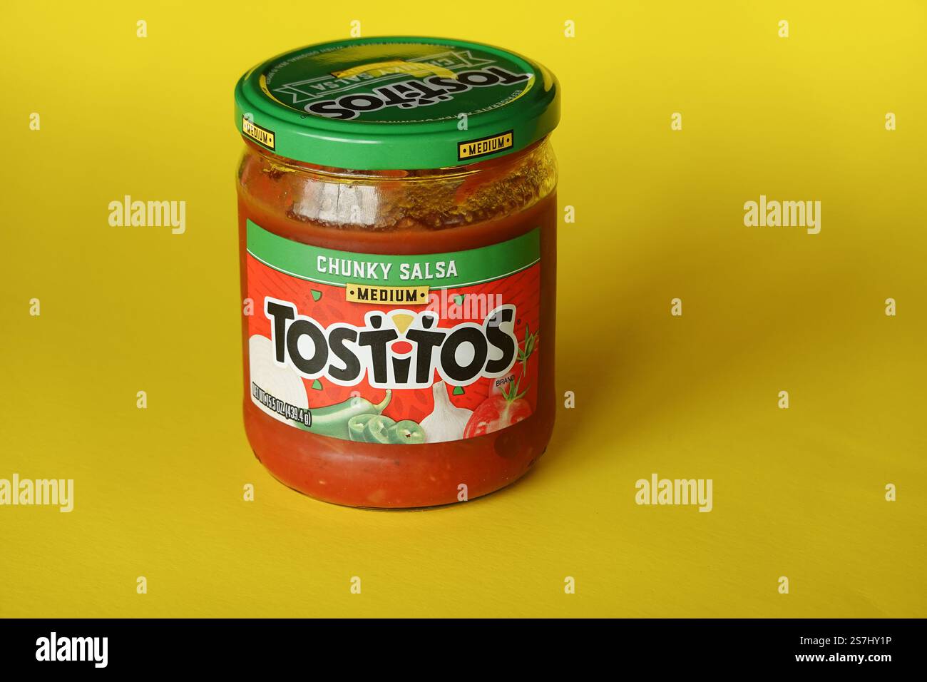 Tostitos Chunky Salsa jar on a yellow background Stock Photo
