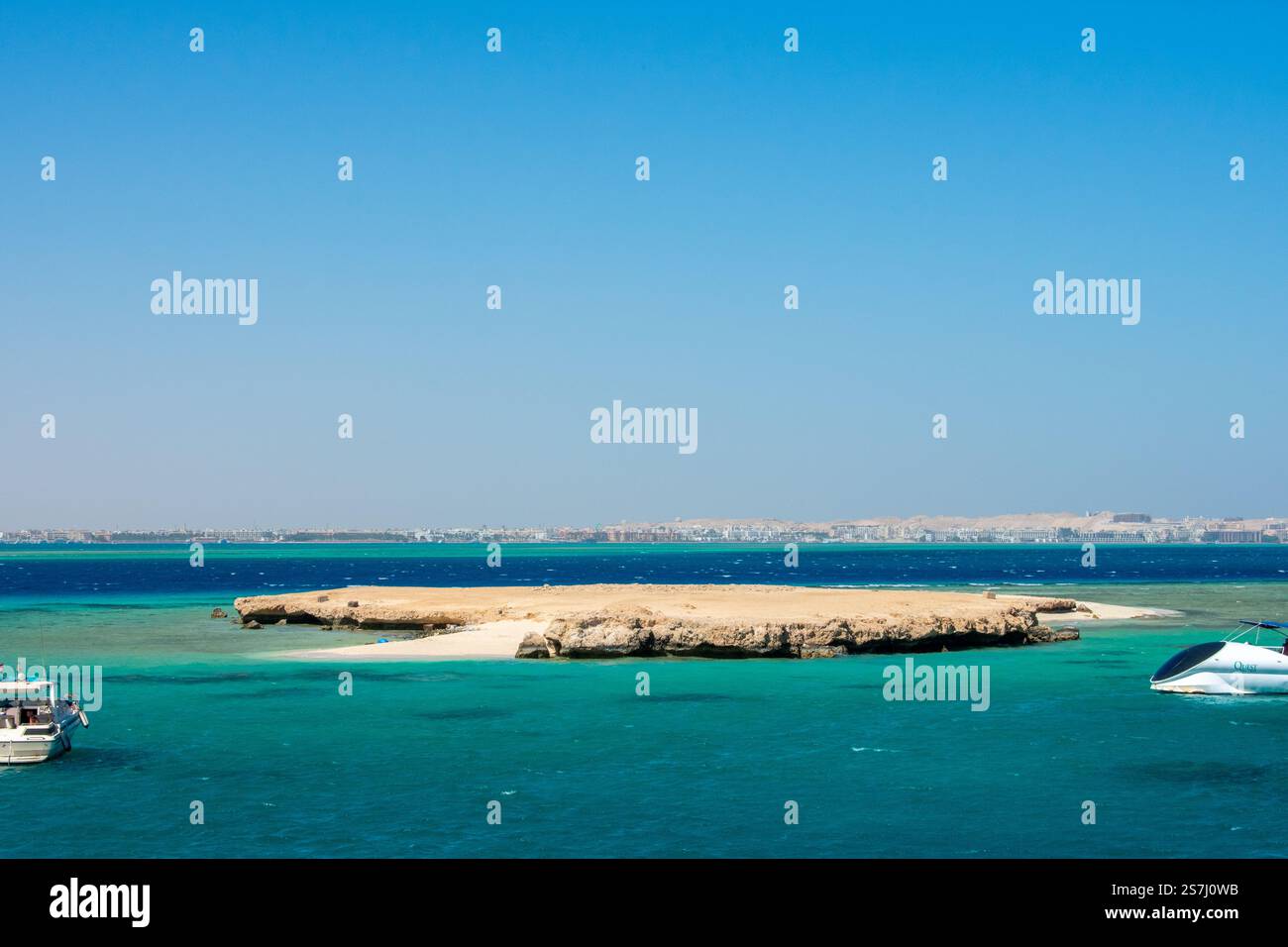 21.01.24 Hurghada, Egypt: Cristal Clear turquoise water of Red Sea at Orange Bay in Giftun Island. Luxury Yachts near Beach at Hurghada, Egypt. Stock Photo