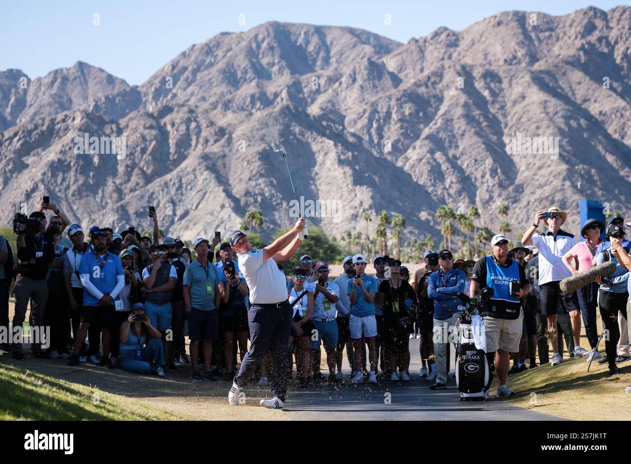 Fans watch as Sepp Straka hits toward the fifth fairway at the Pete Dye