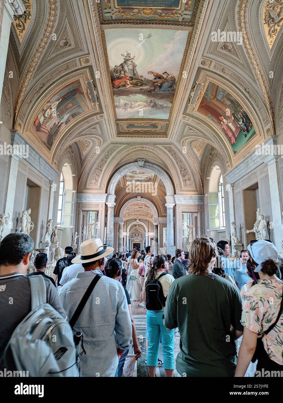 A grand hall where art and history tower above a sea of visitors, each step echoing centuries of culture and curiosity. - Smartphone Captured Stock Image
