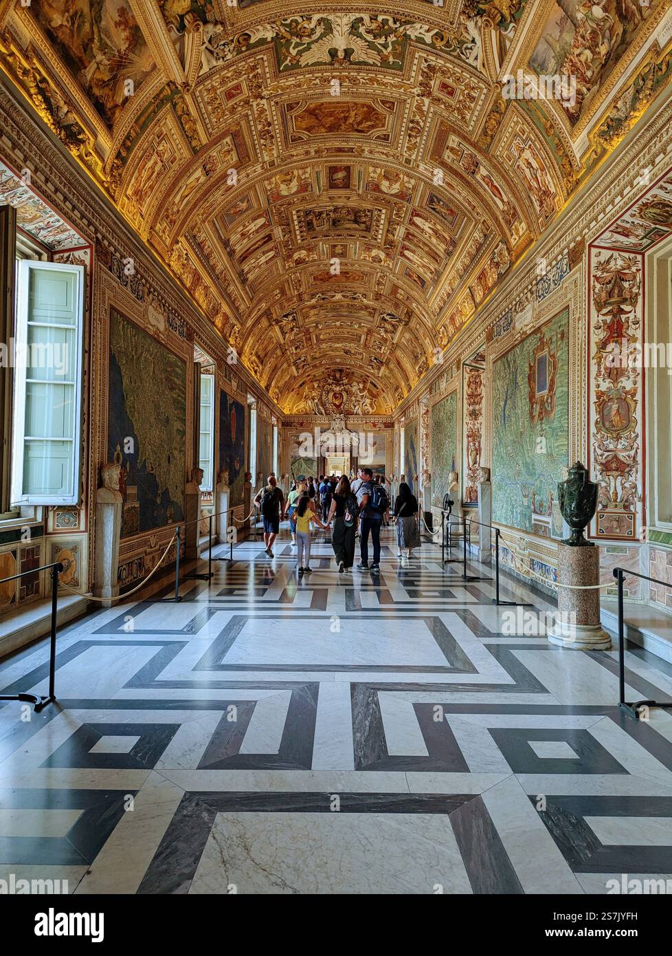 A corridor of grandeur, where gilded ceilings and intricate maps guide visitors through centuries of history. - Smartphone Captured Stock Image