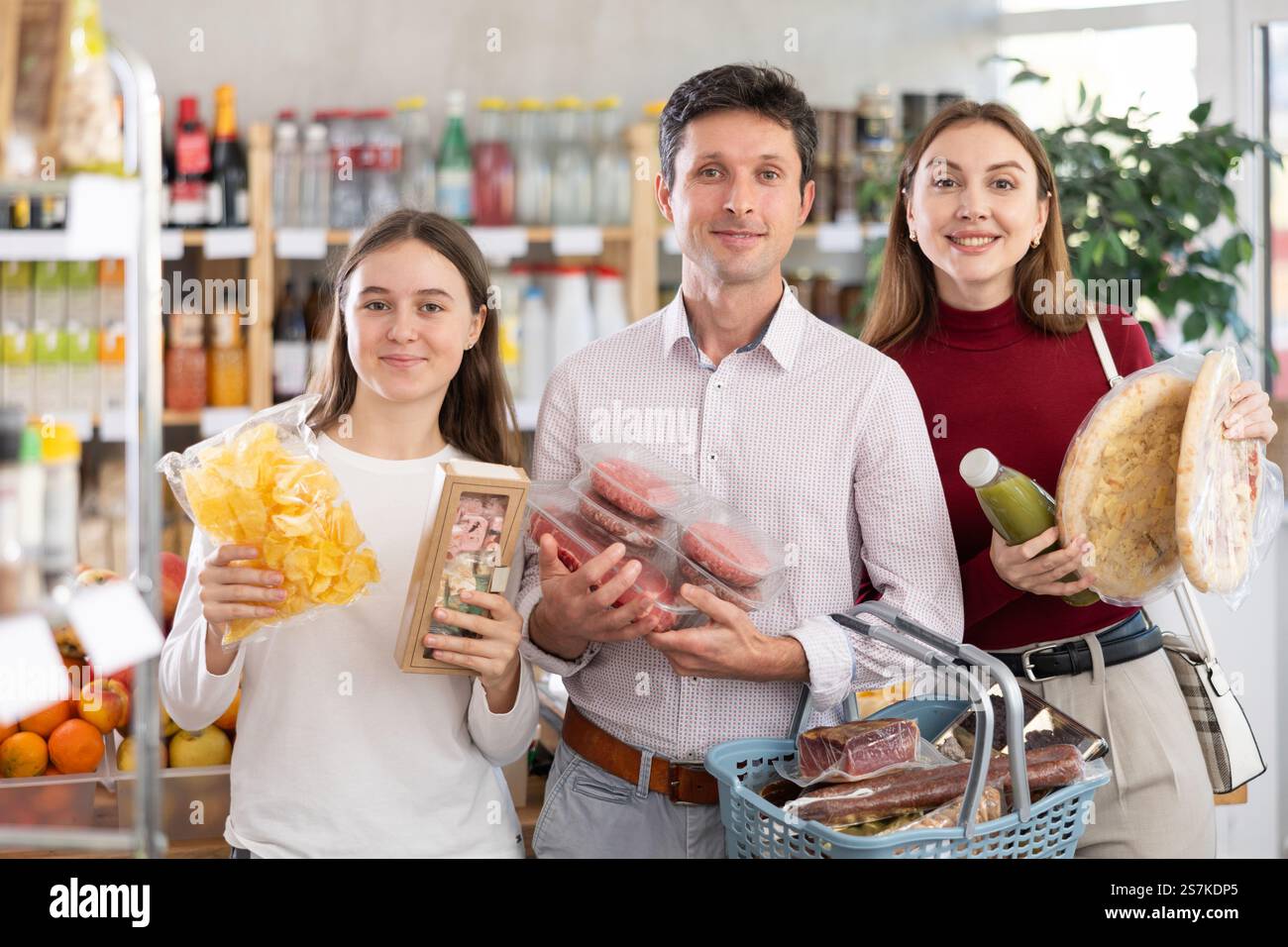Store Something In store, family with purchases in hands looking for something on shelf ...
