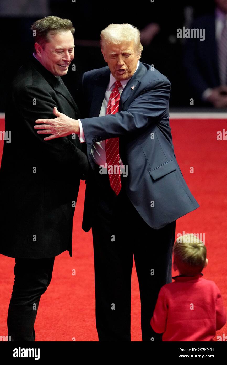 Elon Musk, left, and Presidentelect Donald Trump embrace as they look
