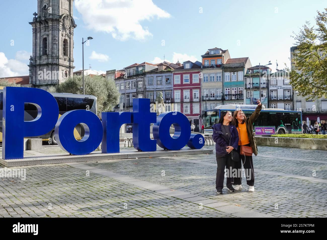 Tourists taking selfies in front of the big Porto sign, capturing the ...