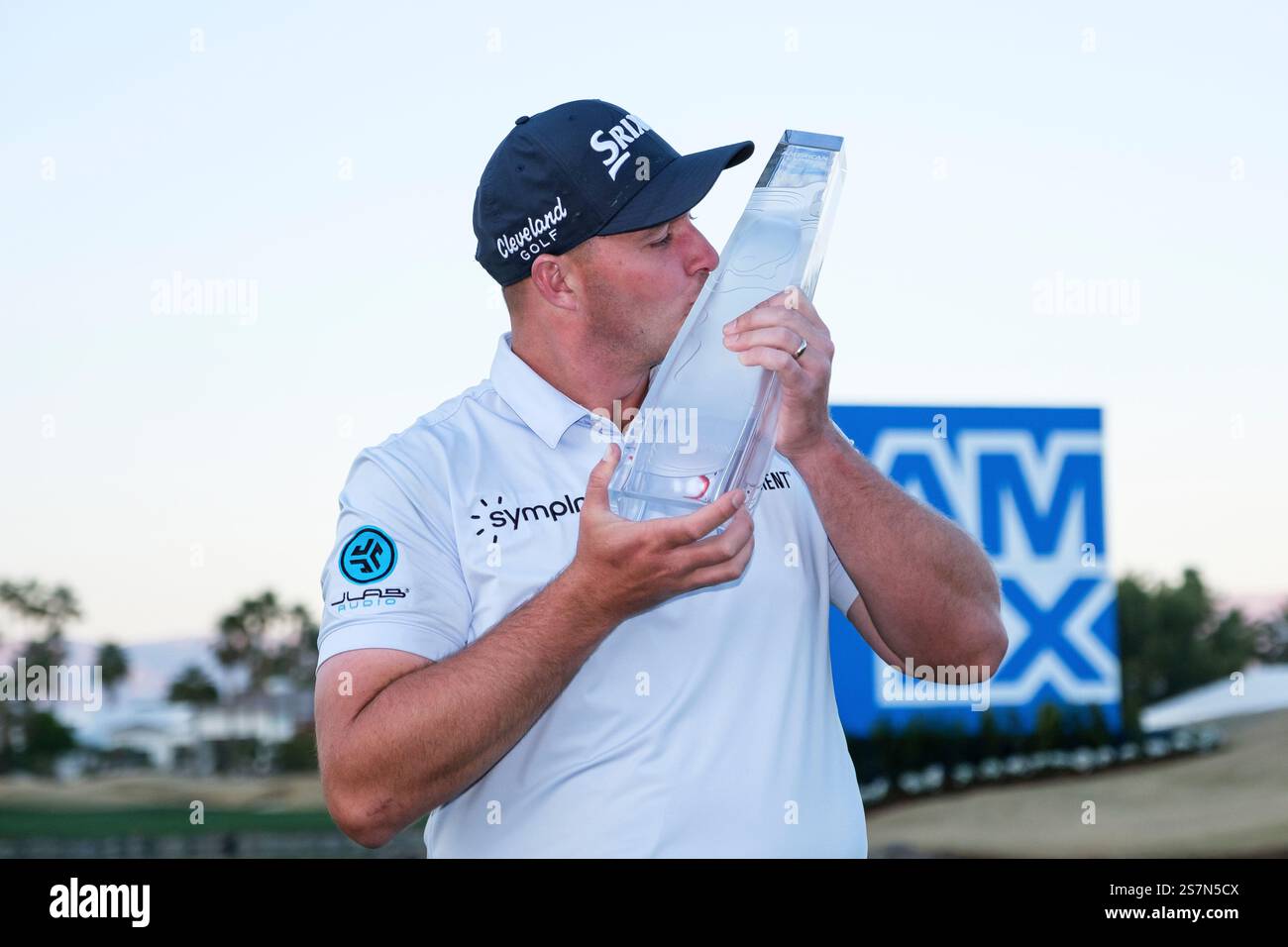 Sepp Straka kisses the trophy after winning the American Express golf