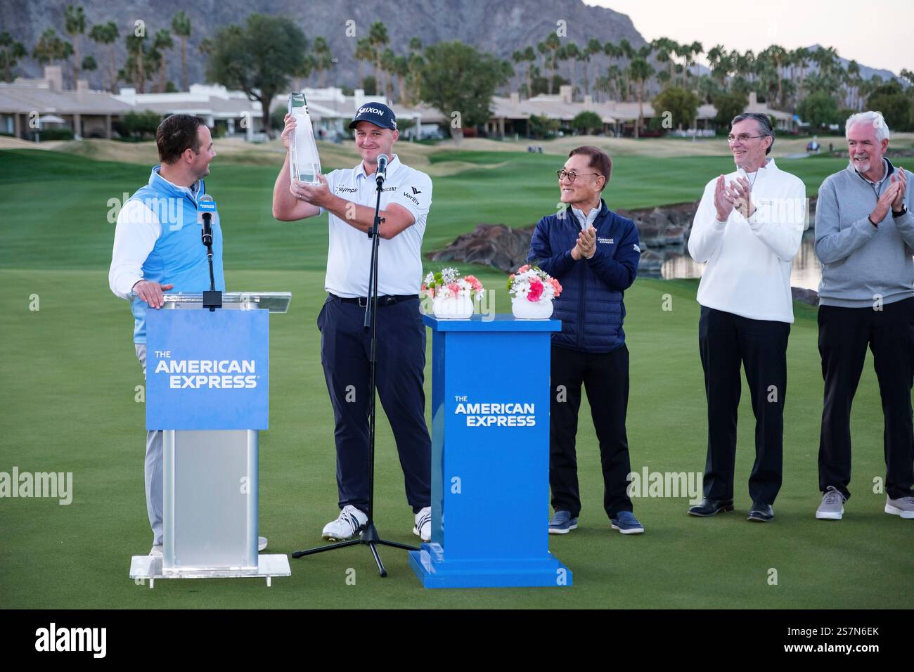 Sepp Straka, second from left, holds the trophy after winning the