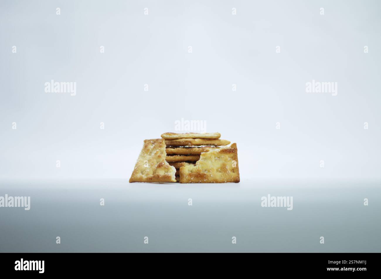 Stack of Salty Crackers Isolated on a Plain White Background Stock Photo