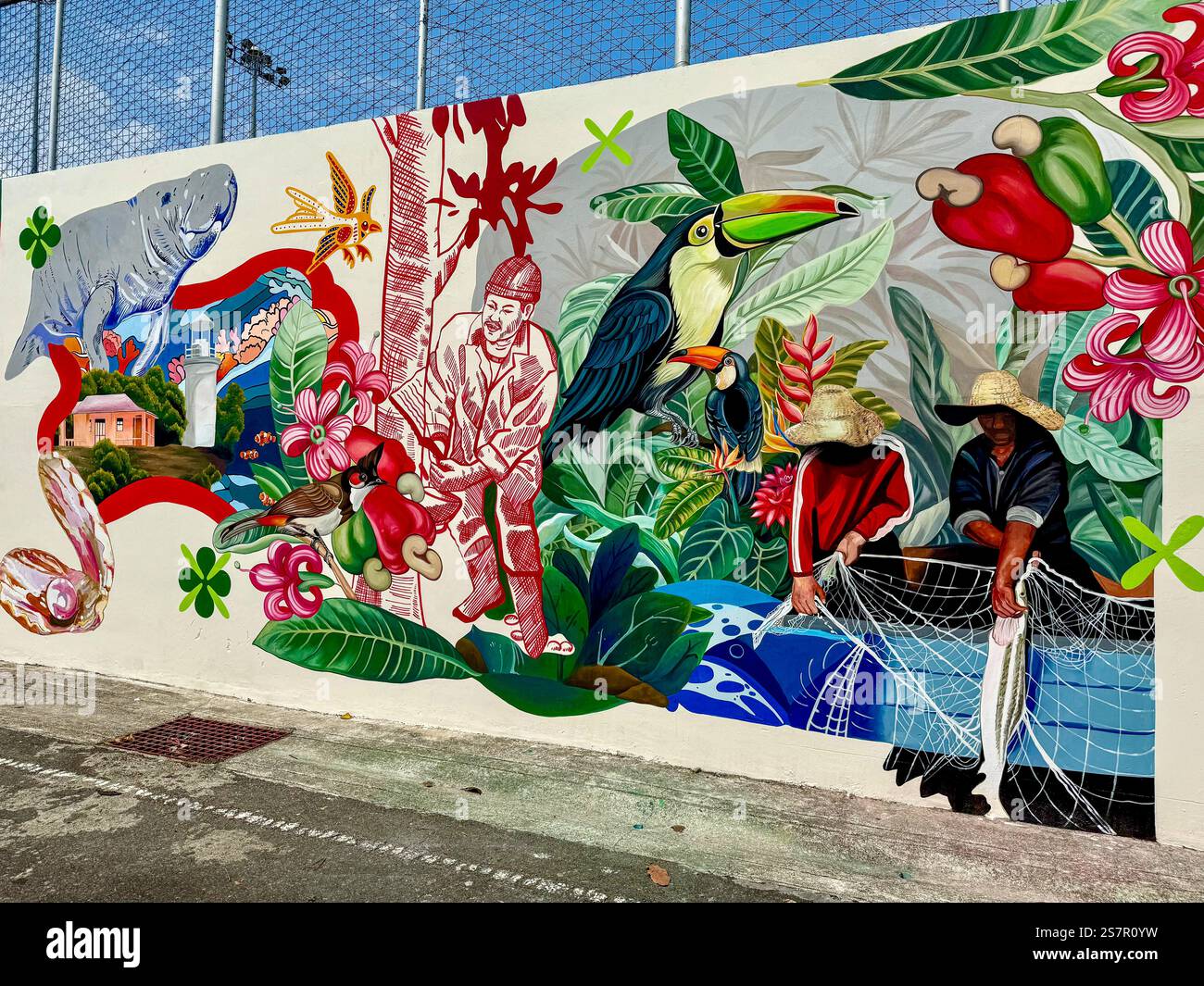 A vibrant and detailed mural showcasing a blend of exotic wildlife, tropical flora, and local traditions. The artwork features toucans, a manatee, tro - Smartphone Captured Stock Image