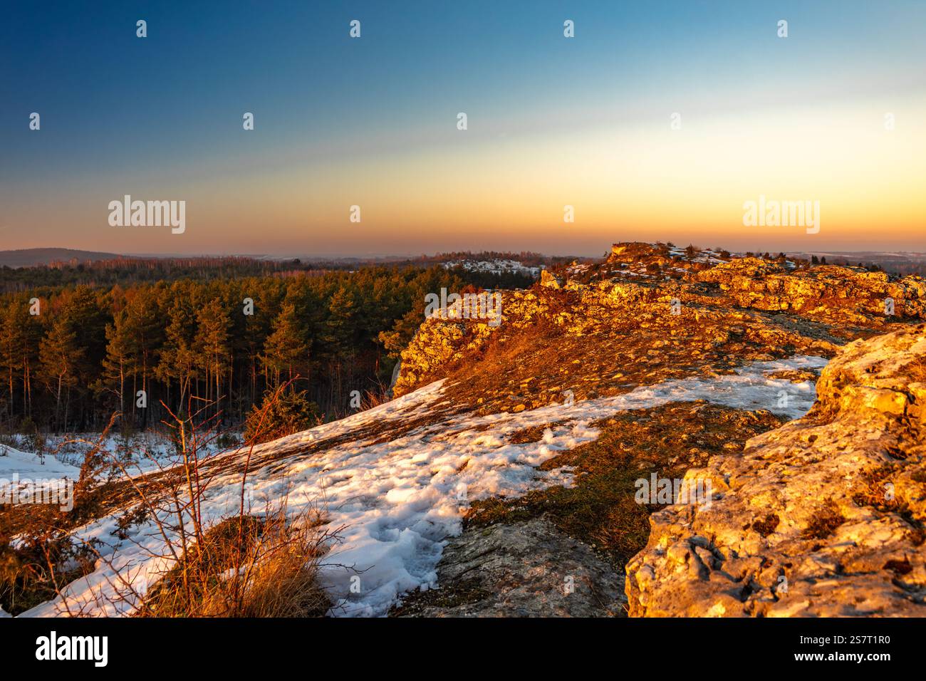 Sunset in winter over the mountain peaks, Krakow-Częstochowa Jura, Towarne Mountains, play of colors in the sky Poland Stock Photo