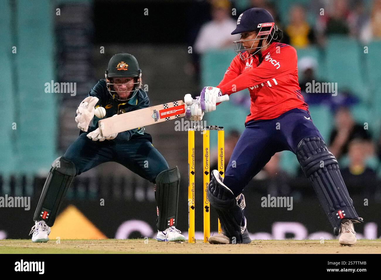 England's Sophie Dunkley, right, bats in front of Australia's Beth ...
